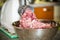 An electric meat grinder twists the meat