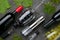 Electric metal corkscrew, wine aerator and vacuum stopper. On a gray concrete background. Glasses, grapes and bottles of wine lie