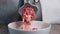 Electric mincer machine makes raw meat minced. Process of grinding meat in the kitchen at home