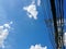 Electric pole of the high voltage electric wires and communication cable on blue sky background