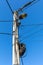 Electric pole with wires and power equipment. street light electricity front view isolated with blue sky. power electricity pole