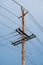 Electric pole and wires, wood electricty pole on blue sky background.