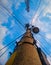 Electric poles and cellphone signal transmitting towers against blue sky