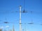 Electric power grid and pillars poles as a part of city trolleybus system against blue sky.