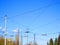 Electric power grid view as a part of city trolleybus system against blue sky.