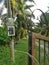 Electric power meter box fixed to the pole with DANGER signboard written in Malay word `BAHAYA` at the farm entrance