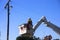 Electric power worker preparing to change street light