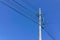 Electric powerline with pole and wire with clear blue sky background