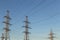 Electric powerlines. High voltage power lines, pylons against blue sky