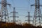 Electric powerlines. High voltage power lines, pylons on blue sky background