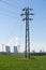 Electric pylon with nuclear power plant background