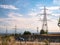 Electric pylons at sunrise behind a highway