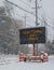 Electric road traffic mobile sign by the side of a snow covered road with snow falling that says, Don`t Drink and Drive.