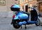 Electric scooter. light blue rental moped. old urban historic city setting.