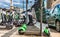 electric scooters parked in a row in avenida, lisbon in a beautiful day. date may 20 2019. modern electric scooters parked