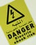 Electric shock risk, danger sign board label in black letter in arabic letter also with yellow background