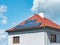 Electric solar panels on the tiled roof of family house. The insulated facade