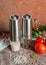 Electric spice mills. With Himalayan salt and pepper. Stand on the table. Nearby vegetables