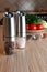 Electric spice mills. Stand on the table on the table. Nearby are cups with spices and vegetables