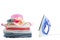 Electric steam iron and Pile of colorful clothes isolated on wh