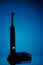 Electric toothbrush silhouette, blue background