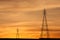 Electric Transmission Towers in orange sunset.