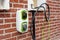 Electric vehicle domestic charging point installed outside of house on new housing development as part of green energy program