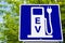 Electric Vehicle Recharging Station Sign with Trees in Background