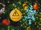 Electric warning sign hang on Christmas tree with light bokeh background