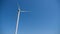 Electric wind turbine stands in a field