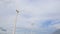 Electric windmill that generates electricity due to the rotation of the screw from the wind, blue cloudy sky, copy space