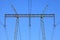 Electric wires against the blue sky. High voltage powerline tower