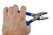 Electrical Crimping stripping pliers with blue rubber handle held in left hand of adult male person, opened jaws, white background