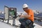 Electrical Engineer Holding Book While Analyzing Electricity Box