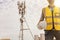 Electrical engineers work on telecommunication. tower holding a helmet and safety equipment on a tall telecommunication tower