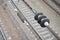 Electrical insulators on the contact wires on the background of a blurred railway track. Macro photo with selective focu