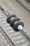 Electrical insulators on the contact wires on the background of a blurred railway track. Macro photo with selective focu