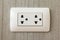 Electrical outlet on wood wallpaper.