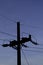 An electrical pole silhouetted