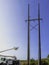 Electrical poles, cables, and repairing utility bucket truck parked in the woods