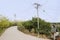 Electrical poles by curving countryroad in sunny spring