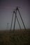 Electrical poles on a meadow