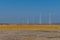 Electrical power towers at edge of open field