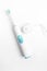 Electrical toothbrush with accumulator charger on white background, top view