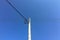 Electrical tower with blue sky background. Old simple rural weathered wooden utility pole with parallel cables and insulators on