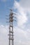 An electrical tower stands tall against the blue sky