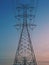 Electrical Transmission power line tower post pole against blue sky