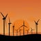 Electrical windmills silhouettes over sunset,  green energy concept