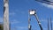 Electrical Workers On Telehandler With Bucket installing High tension wires