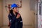 Electrical young asian woman engineer examining maintenance cabinet system electric and using radio in control room.